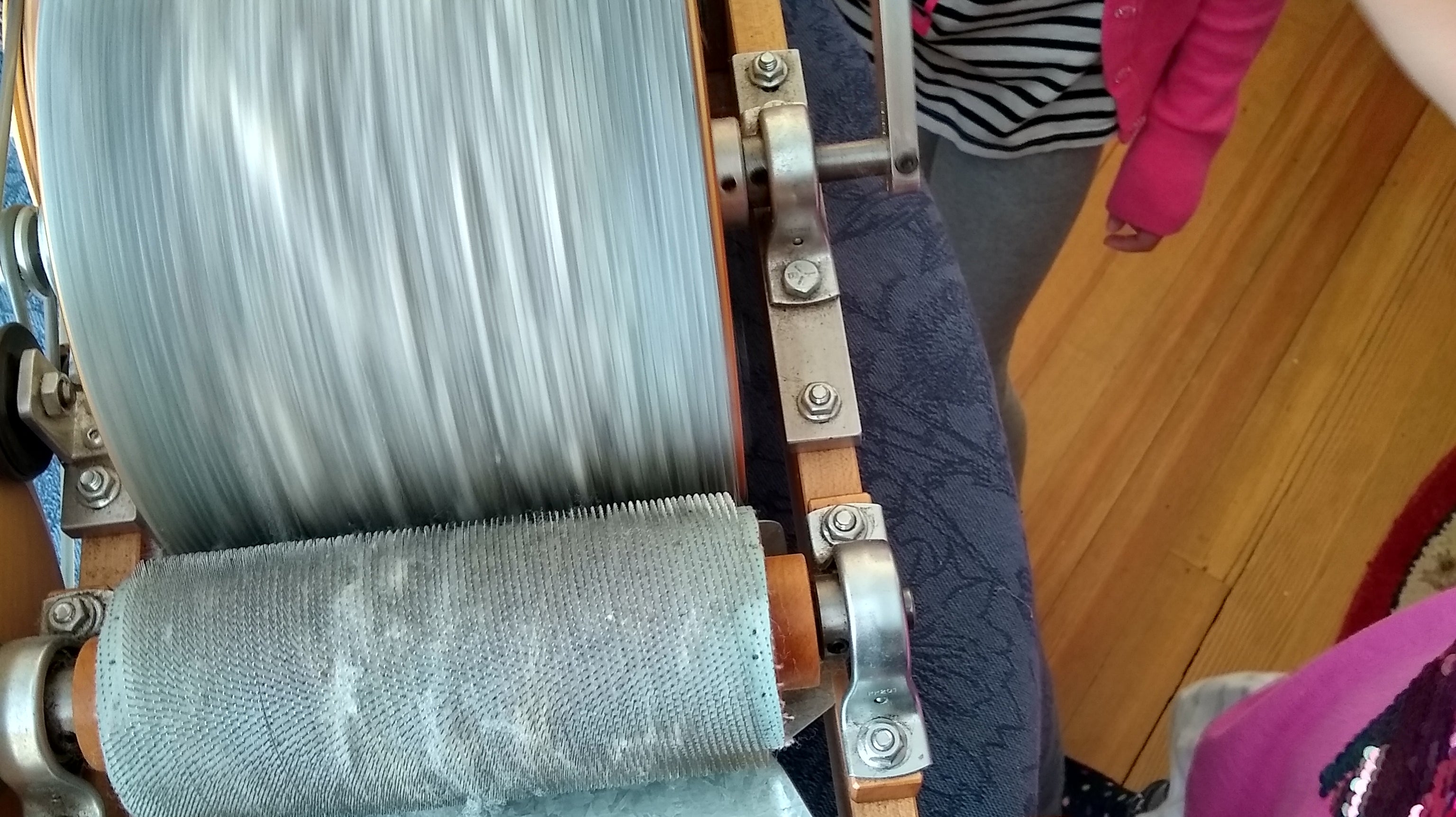 Children using a drum carder